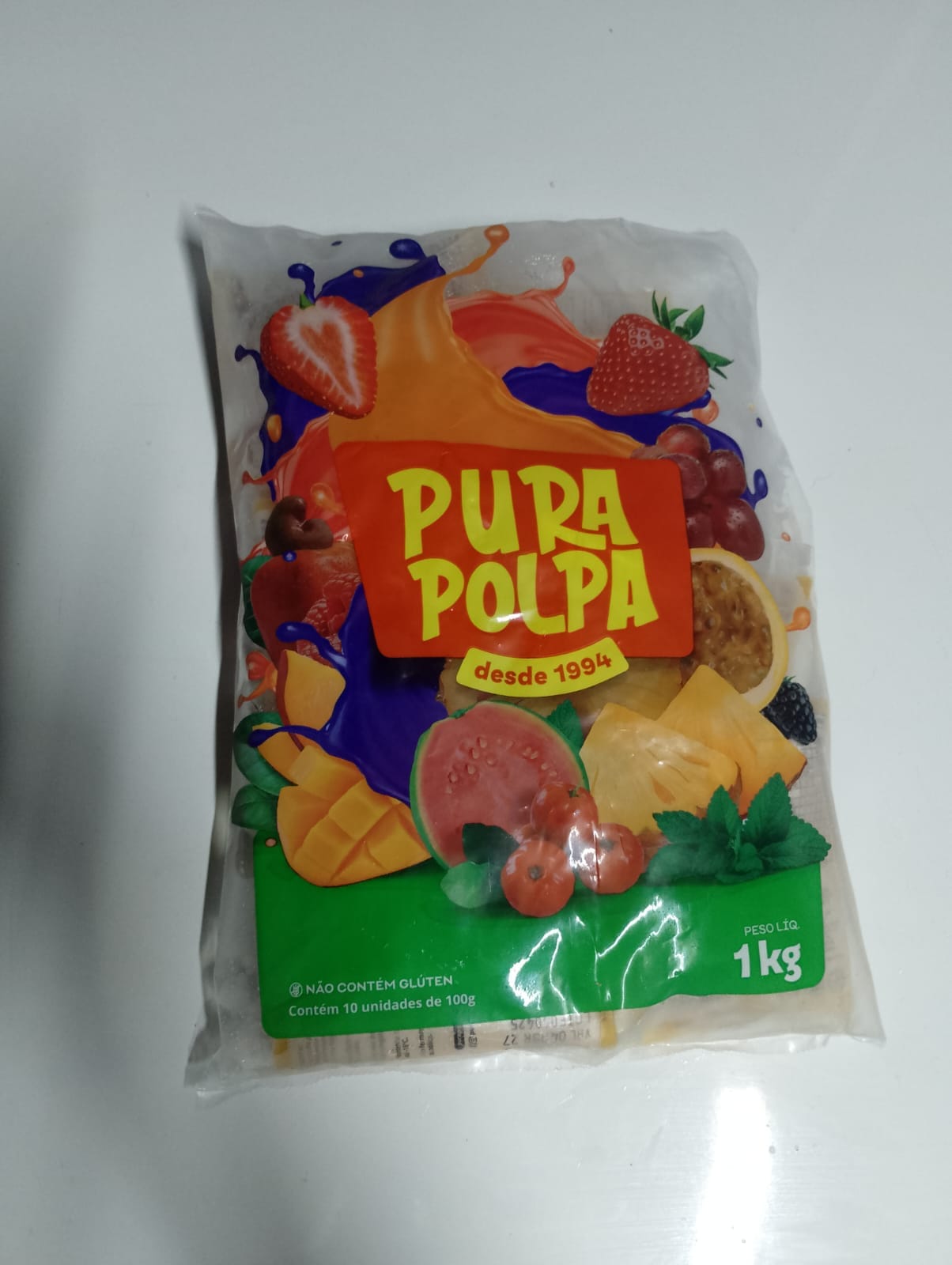 Frente do pacote Pura Polpa de 1 kg, contendo 10 unidades de 100 gramas